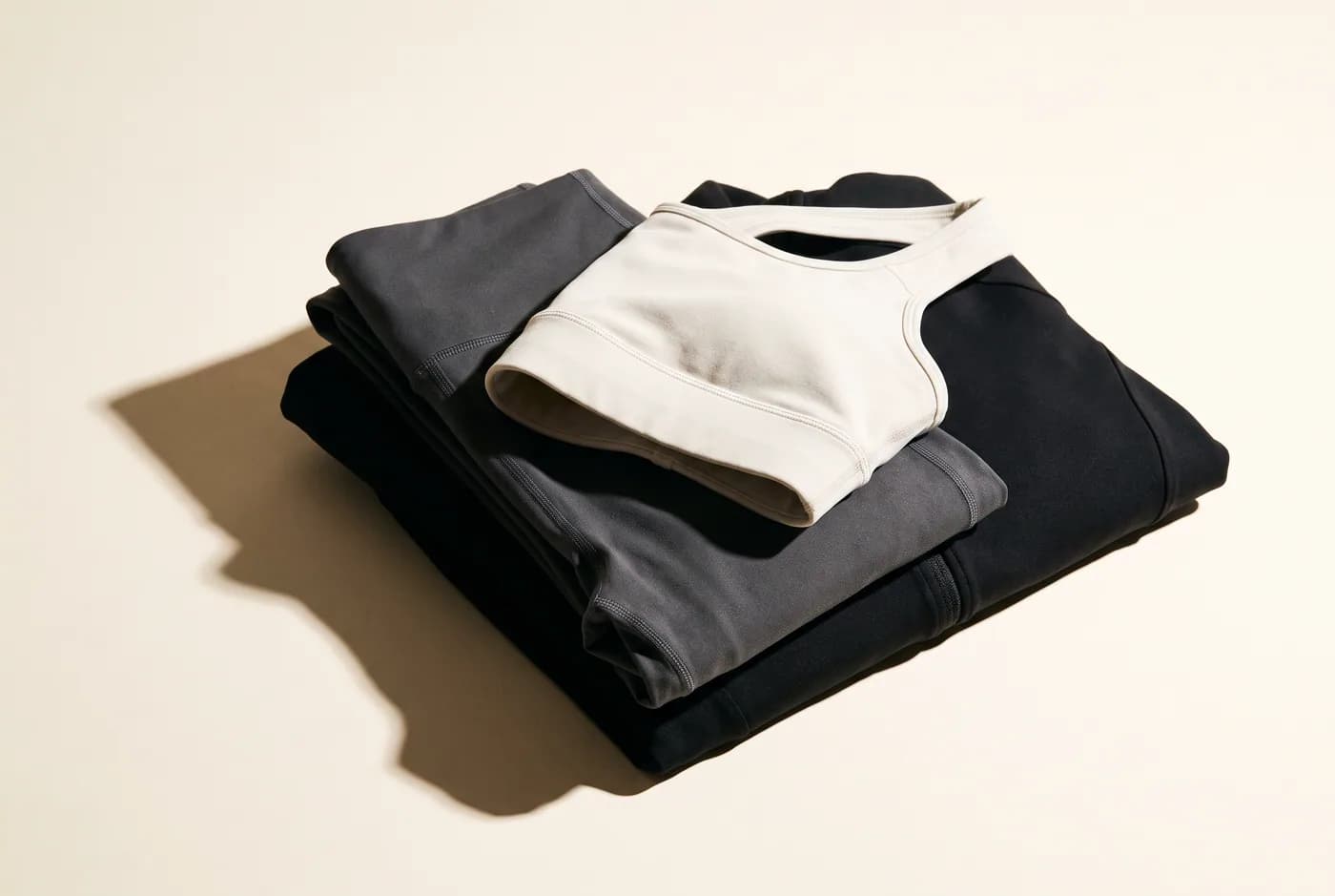 Folded technical-knit leggings with a sports bra resting on top