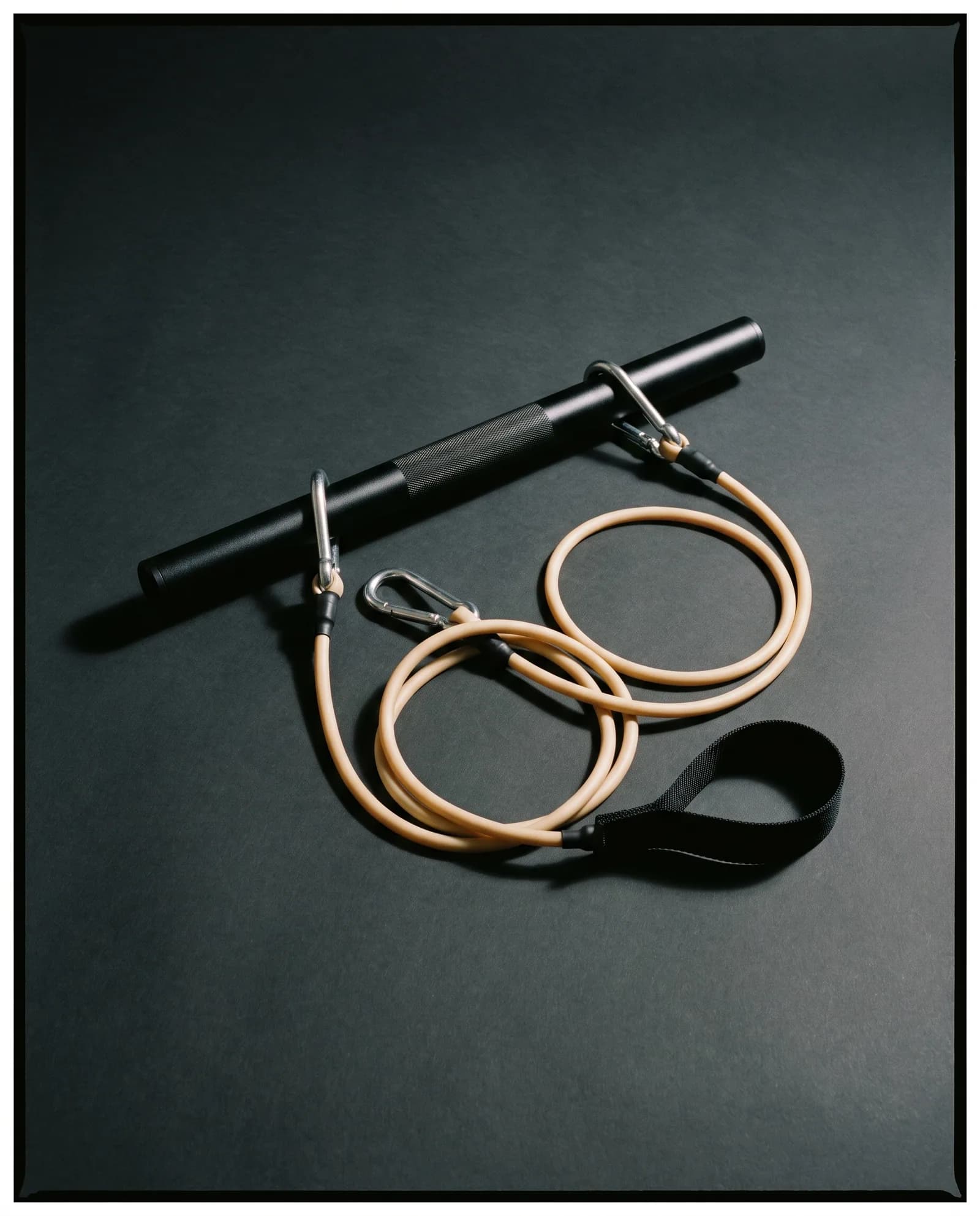 Resistance Bar — Anodised bar with detachable latex cords.