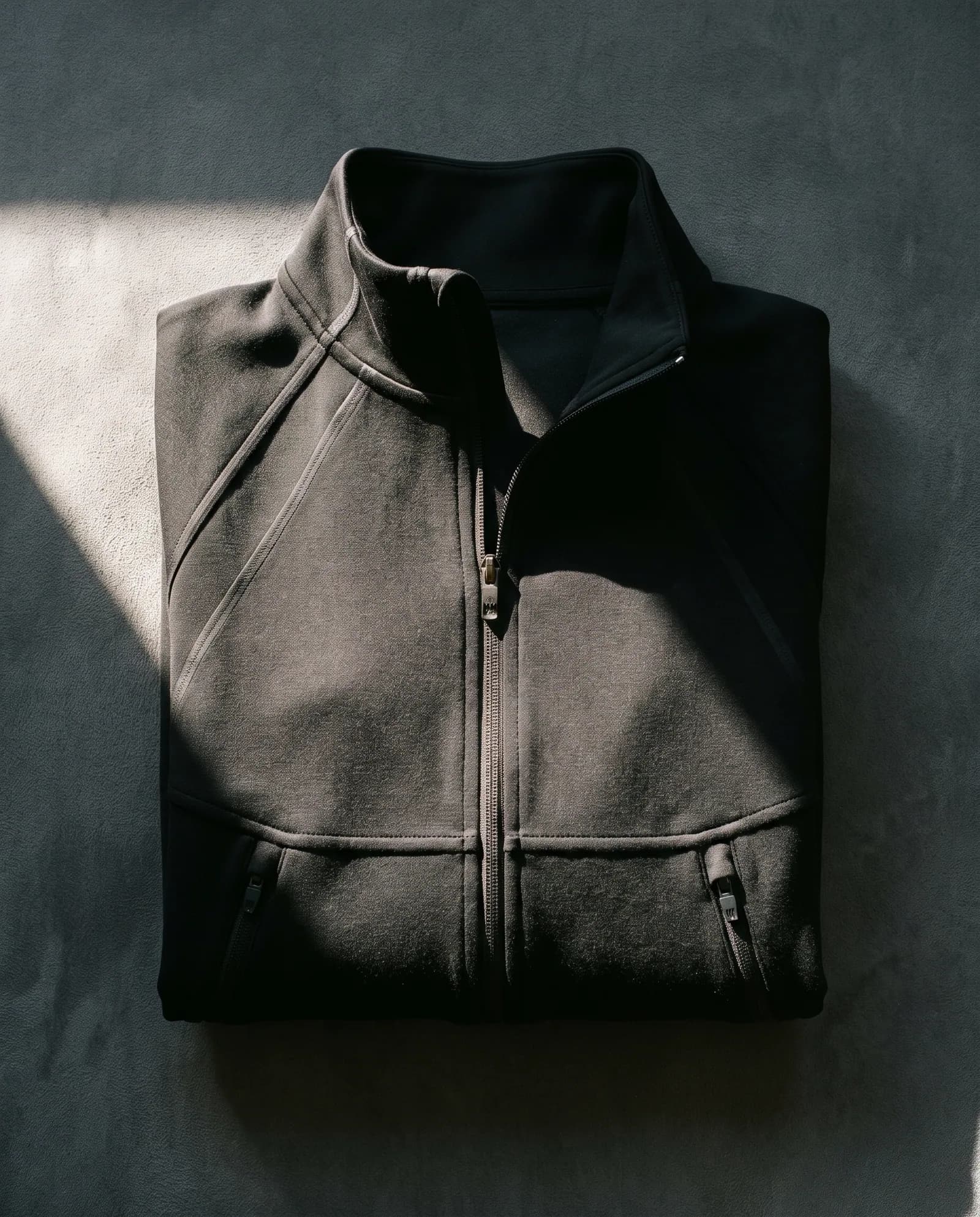 Studio Jacket — Full zip, bonded seams, cut for layering.