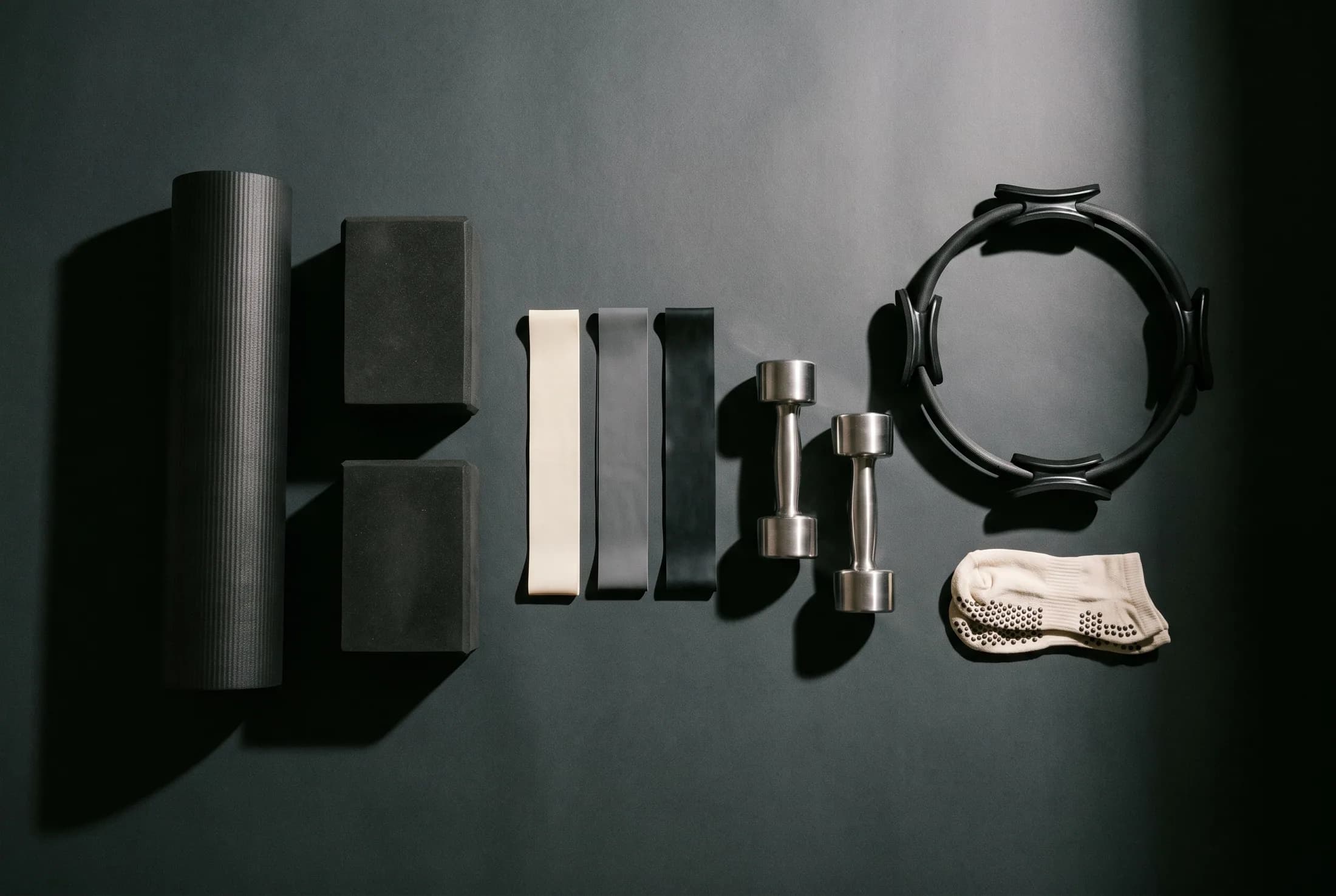 The full kit laid out — mat, blocks, bands, hand weights, ring and grip socks